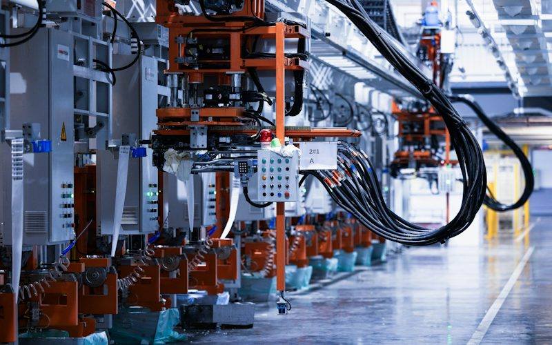 Factory automation line with industrial control panels and PLC equipment
