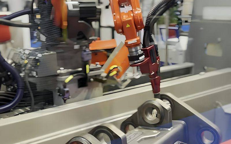Industrial robot welding a part on an automated factory line