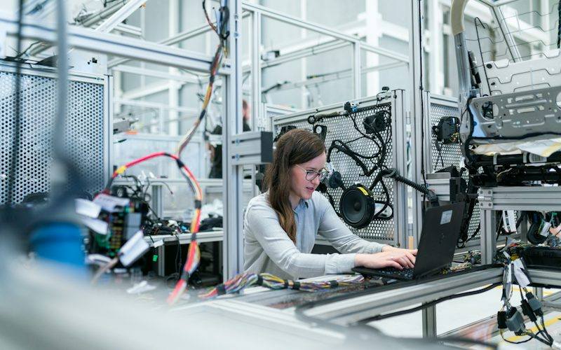 Engineer on a manufacturing line using production management software